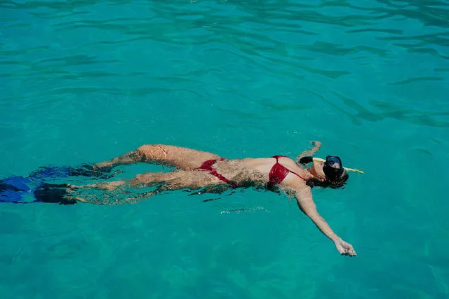 Guest floating in clear turquoise water
